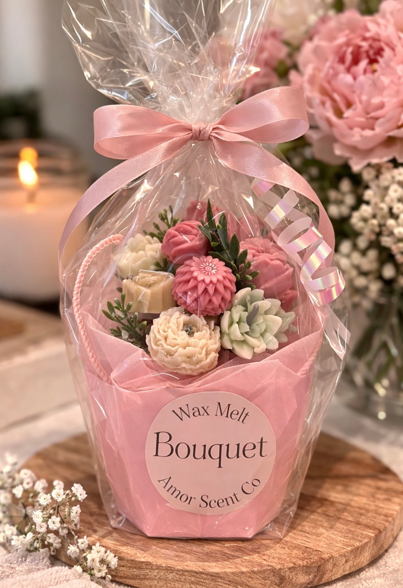 Wax melt bouquet in a clear cellophane bag with a pink ribbon on a wooden surface.